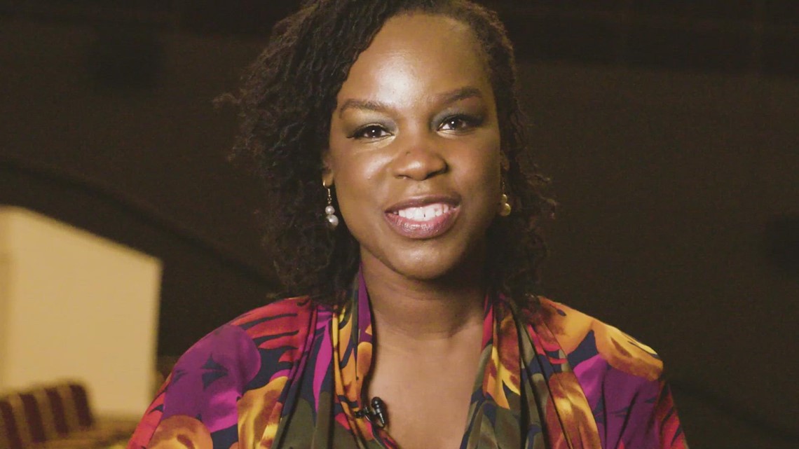 Dr. Timmie Foster smiling warmly, wearing a vibrant floral blouse and pearl earrings